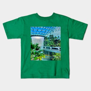 A roof waterfall with passing sky trains in Changi airport 1 Kids T-Shirt